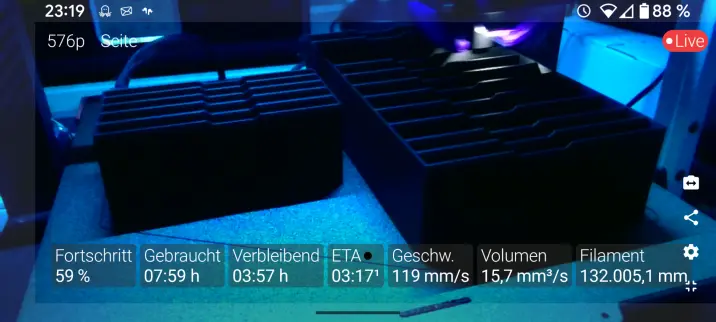 some blue-ish view of the printed where the print head is working

There are two dark boxes on the bed and the ETA for this print is around 3am. The overall print time will be around 11hrs