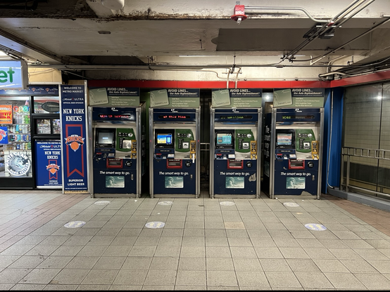 Four empty payment booths for the PATH trains in the underground