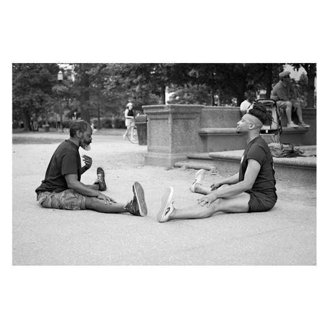 Yoga instructor teaching his student at Meridian Park in Washington DC