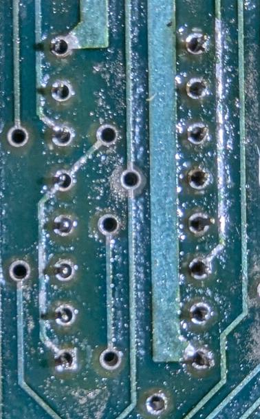 Closeup of the solder side of the board for a 16-pin chip, showing the result of desoldering. Clean holes!