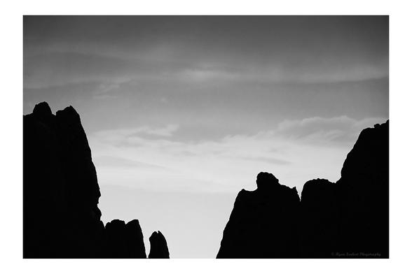 Large rock monoliths in Garden of the Gods, silhouetted against the evening sky.