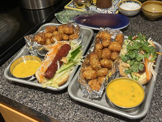 PDT inspired hot dogs, sort of in the style of banh mi, with tater tots, and cheeze whiz with pickled jalapeños.