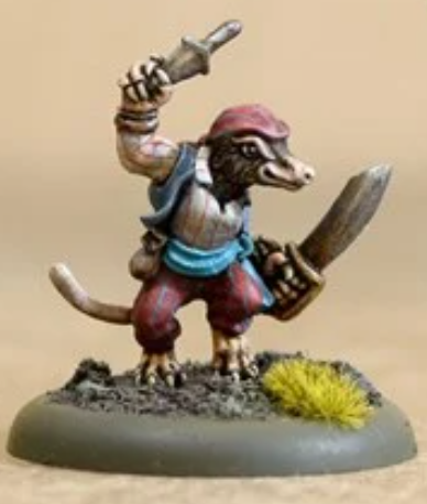 We have a 28mm model of an anthropomorphic shrew. He's facing to the right and has a cutlass in his left hand and brandishing a dagger ready to throw above his head in the right. He has a red bandana and trousers, a white shirt and a blue waistcoat. His face is showing an evil grin.