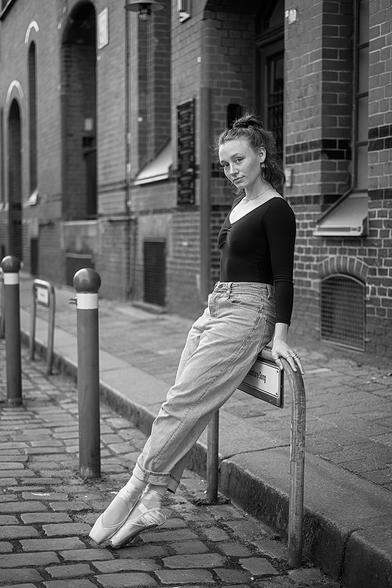 Ballerina auf einem Parkschild in der Speicherstadt sitzend