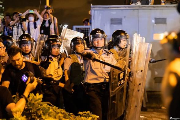 Hong Kong police charging into the area wearing riot helmets, riot shields and batons out near the Central Government Offices in Admiralty.