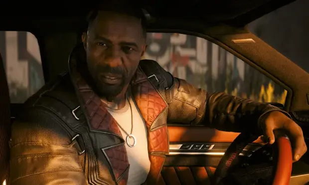 Idris Elba con la mano en el volante nos mira inquisitivo.