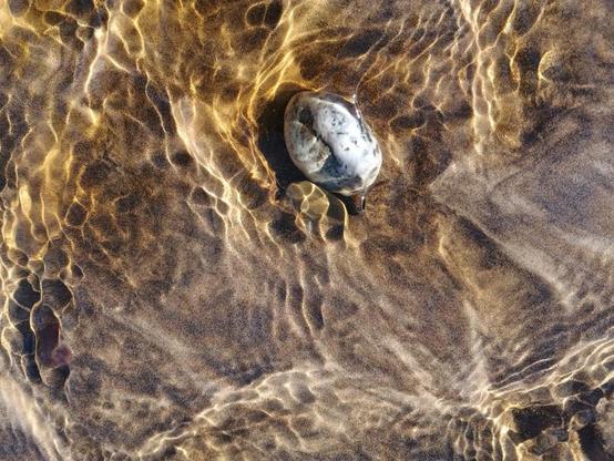Beautiful patterns in a stream running down to ocean beach