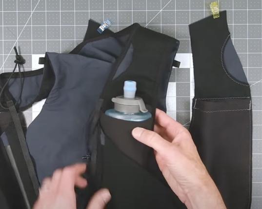 midway constructing a vest that holds a couple water containers and has other pockets ideal for no-bounce while running