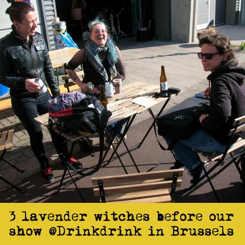 3 of my band mates relaxing at outdoors tables before a gig. Text: "3 lavender witches before our show @Drinkdrink in Brussels".