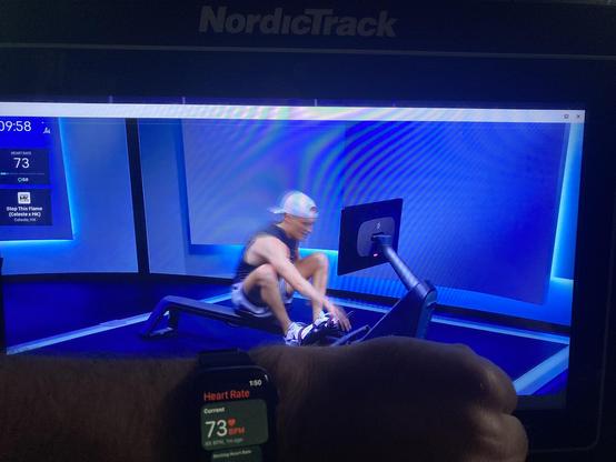 Screen of a nordictrack rower in the background with an apple watch and arm showing a heart rate of 73bpm.

On the nordictrack is the peloton application showing a rowing video and the synced heart rate from the apple watch.