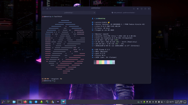 Screenshot of Aurora Plasma 6 desktop. Ptyxis terminal emulator is in the middle of the screen showing the output of the Aurora's custom fastfetch program.