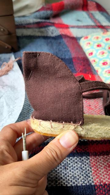 The heel has been hand stitches in place and there's a pin marking the place where the heel needs to be taken in to work better.
