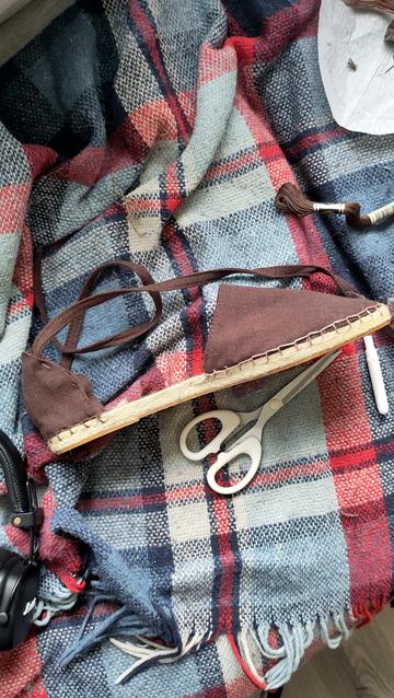The same shoe stitched together with the straps in a slightly different place than in the previous photo. The front has been stitched with a light embroidery floss while the back has been stitched with a darker one.