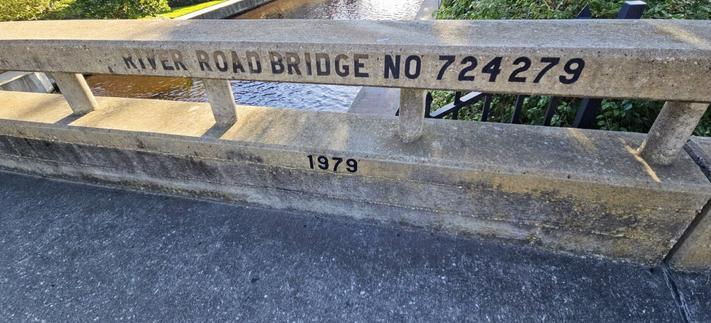 View over the sides of a small concrete bridge.