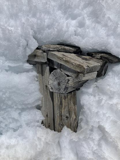 Really old post and beam exposed from the snow. There's some thick wood shingle on the top.