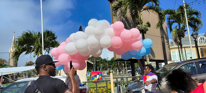 stream of balloons in trans flag colours