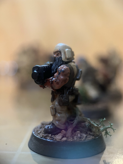 Close up of a sleeveless dwarf mini with tattoos and a big gun.