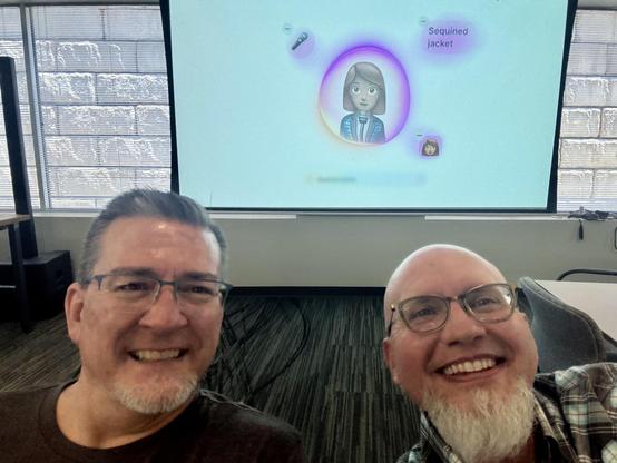 Two developers (me on the right) with the WWDC keynote on a screen in the background.