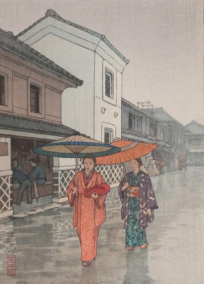 Two Japanese women carrying umbrellas walk down a street on a rainy, overcast day. Both women are wearing traditional dress and wooden geta; the woman in front is carrying a small package wrapped in red cloth. Further down the rain-slicked street, other figures are trying to stay dry and avoid the rain.