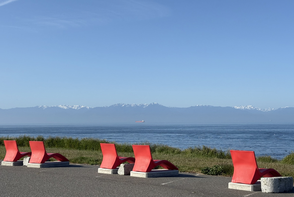 Red lounge chairs installation at Clover Point, Victoria BC. This happens to be the one day a year which is perfect for trying them out for a spectacular view of the Salish Sea and the Olympic Mountains.