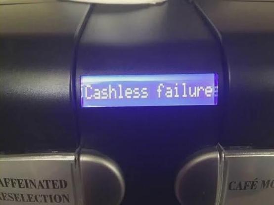 a coffee machine display saying "cashless failure"