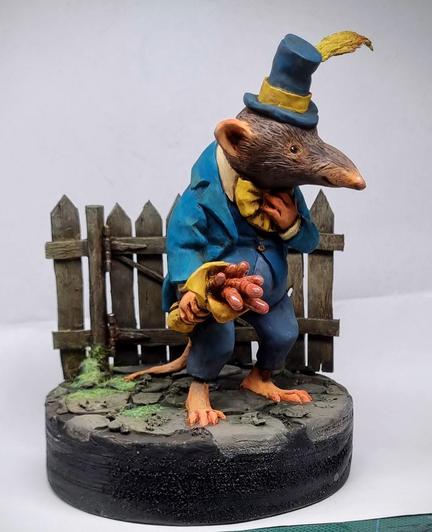 Clay sculpture of a shrew with a worm bouquet by Victoria Maderna.