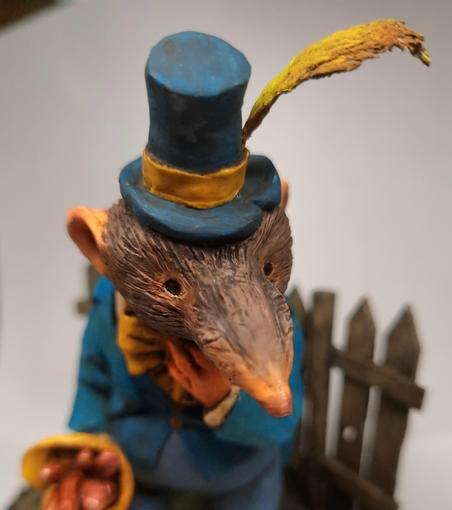 Clay sculpture of a shrew with a worm bouquet by Victoria Maderna.