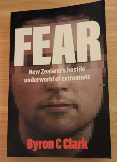 The cover of the book "Fear" by Byron C Clarke. The cover shows a pākehā man with pixelated features and the title "Fear" at the top of the page