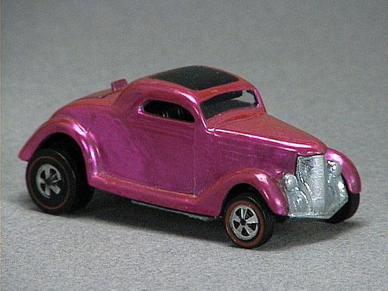 Released in 1969, Spectraflame Magenta Classic '36 Ford Coupe of 1969 Hot Wheels with Redline wheels. Notes: Has black painted roof and opening rumble seat in rear. Packaging: 1969 Blister. Metal Body, Metal Base. Made in USA. Scarcity: 7/10