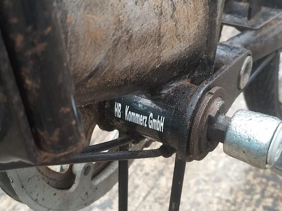 A close-up photo of the bottom bracket (bit where the pedals are) of the bike in the previous photo. On it, painted in white, is 'HB Kommerz GmbH'.
