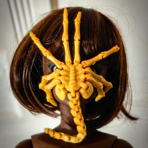 Cocoa Smart Doll with a facehugger on her face.