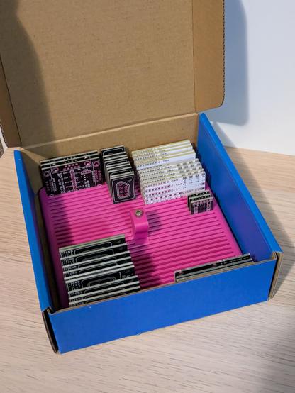 A photo of the whole thing fitting neatly into a small blue cardboard box.
