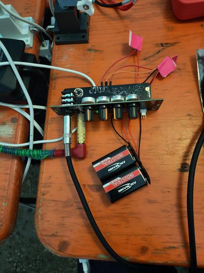 a eurorack module on a table, powered by two 9V blocks