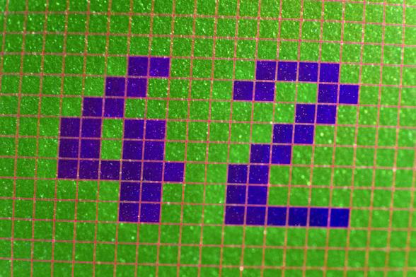 The number 42 written in a pixelated font on an emerald green grid with pink grid lines and deep blue activated pixels. There is a shine to the image