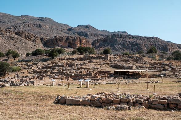Ancient ruins of Kato Zakros set against a rocky mountainous backdrop in Crete.