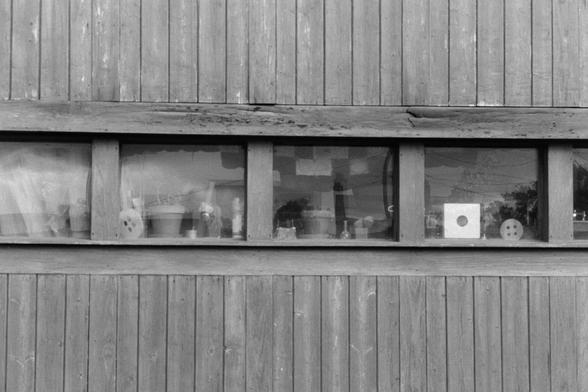 A wood-paneled exterior wall with a row of windows, various knick-knacks in the windowsills

Nikon F100 | Nikon 85mm 1.4 | Kentmere 200 200 @ 800, +2 dev

Home developed in XTOL Stock | 10:45 @ 24C