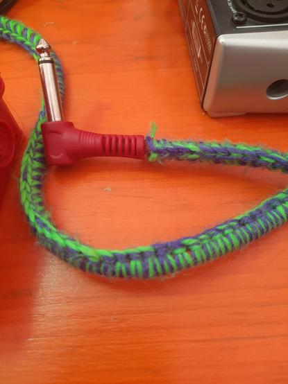 a 6.3mm cable that is knit-wrapped in green and blue