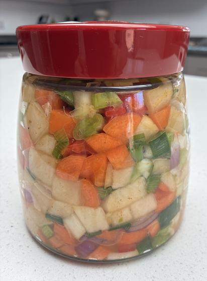 Colourful fresh vegetables for the kimchi - swede, carrots, red pepper, red onion, spring onions, green chilli and red chilli powder.