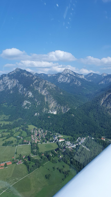 Neuschwanstein in front of the Schwangau mountain backdrop.