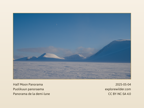 View of the half moon in the blue sky over the glacier and snowy mountains.