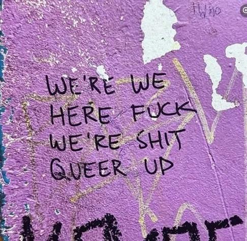 Photo of some graffiti. The artist's intended message was "we're here, we're queer, we fuck shit up", but they wrote it vertically in two columns, which makes it look more like "we're we, here fuck, we're shit, queer up".