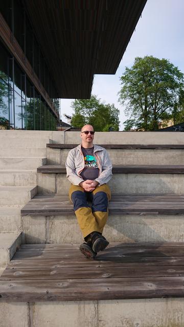 A man sitting outdoors on some steps