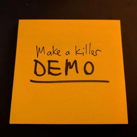 A handwritten post-it note that reads: Make a killer DEMO