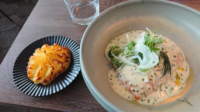 A salmon filet with sauce and garnish, and a side plate of roasted mashed potatoes