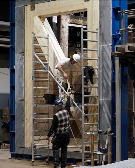 Test assembly CLT frame getting unfired clay masonry