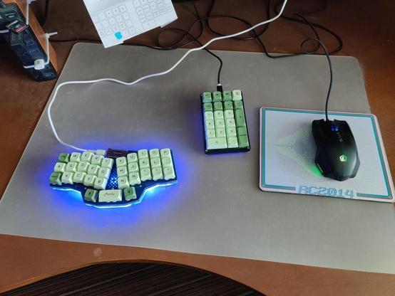 Photo of a computer desk with a 33 key Reviung keyboard and a number pad and mouse next to it