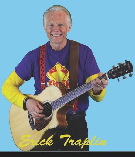 Photo of children's entertainer Erick Traplin, smiling and playing an acoustic guitar, on a bright teal background.