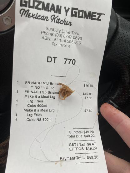 Our receipt from Guzman Y Gomez complete with the very long hair we found in the one meal they did give us of the 2 we paid for.

Always check your drive thru purchases - although if we did, we still wouldn’t have spotted the hair in the meal.
