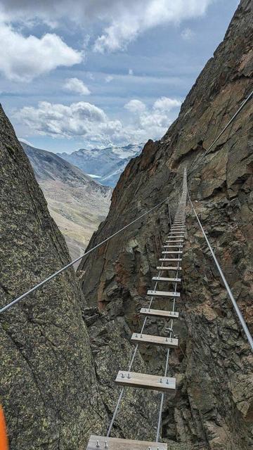 Rope bridge over steep mountain