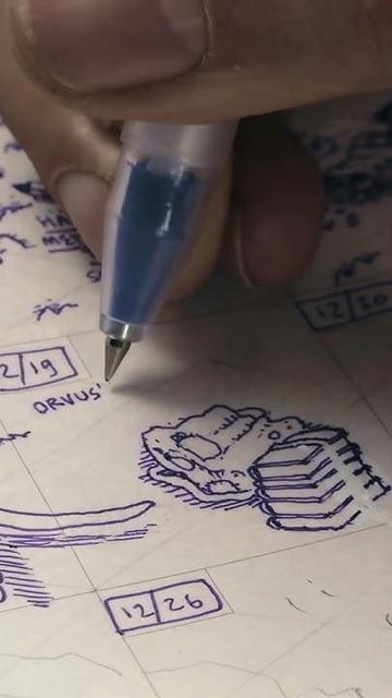 close up of my hand drawing a stack of books and a backpack